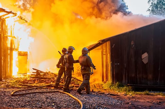 Firefighters extinguish a fire in a farm building. High quality photo