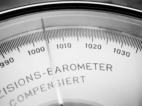 Close-up view of the scale with pointer of an analogue barometer monochrome.