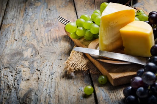 Wine and cheese on rustic wooden table