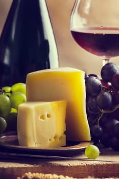 Wine and cheese on rustic wooden table