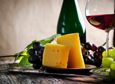 Wine and cheese on rustic wooden table