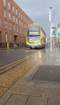 Dublin, Ireland - Feb 9th, 2020: Dublin Bus vehicle driving over wet streets of city, Ireland