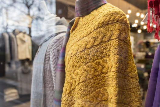 Dublin, Ireland - Feb 9th, 2020: Aran poncho, traditional knitted item with cable patterns. Dublin shop, Ireland