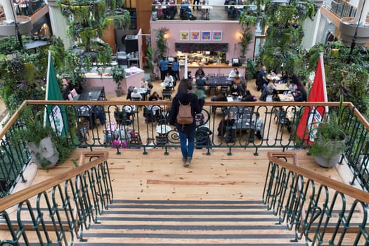 Dublin, Ireland - Feb 7th, 2020: Young woman on Powerscourt Shopping Centre stairs. Dublin, Ireland
