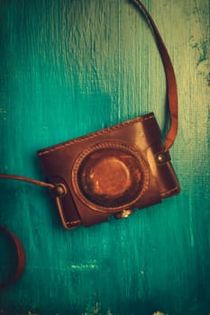 Vintage photo camera on rustic blue background
