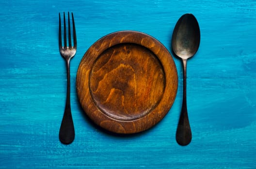 Wooden plate on blue background