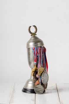 Trophy full of medals over white wall