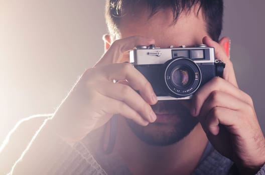 Man holding retro camera