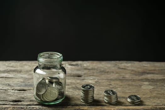 Save money and account banking for finance concept, Hand with coin on piggy bank blurred background