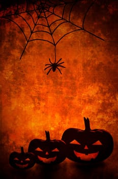 Halloween pumpkins and spider net background