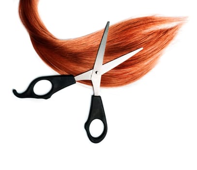 .Long healthy red hair and professional scissors