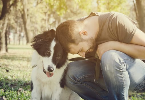 Man with his dog playing in the park