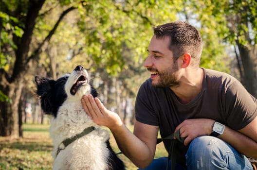 Man with his dog playing in the park