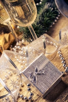 Silver present box and champagne glasses with christmas decoration.