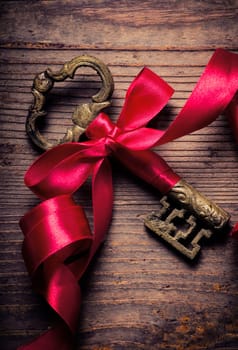 Old key decorated with red ribbon