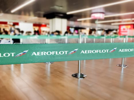 Moscow, RUS, July 2019: Green belt barrier with white Aeroflot airlines logo. Aeroflot is the flag carrier airline of Russia. Travel and airport security