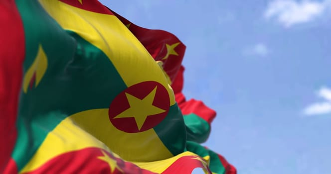 Detail of the national flag of Grenada waving in the wind on a clear day. Grenada is an island country in the West Indies in the Caribbean Sea. Selective focus.