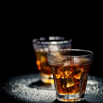 .Two glass of iced cocktail on wet background. Shallow depth of field.