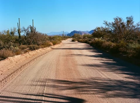 Dirt road leading off into the desert mountains