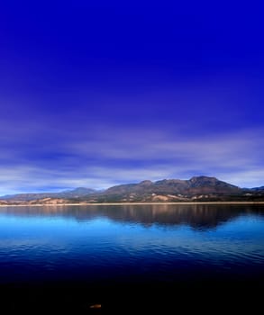 Mountain and reflections of Mountain in Roosevelt lake Central Arizona