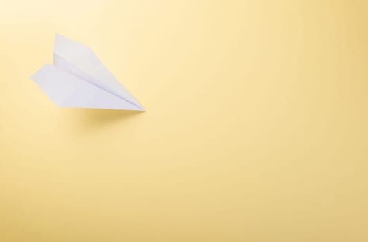 Paper plane letter document message. Top view mock up design of airplane travel tourism, isolated on yellow background with blank empty space for copy space