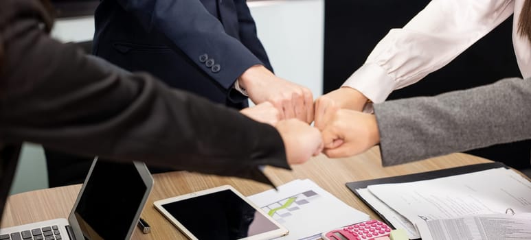 Business people join punching fists bump hands as team their meeting, Giving touch punch together of power teamwork, Business group winning successful company achieving goals with determined staff