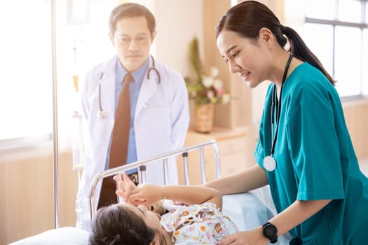 Pediatrician visiting parents and child in hospital bed ward, doctor and nurse meet and talking with patient kid, healthcare medical service treatment process concept
