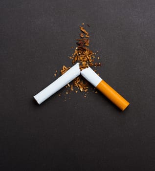 31 May of World No Tobacco Day, no smoking, close up of broken pile cigarette or tobacco STOP symbolic on black background with copy space, and Warning lung health concept
