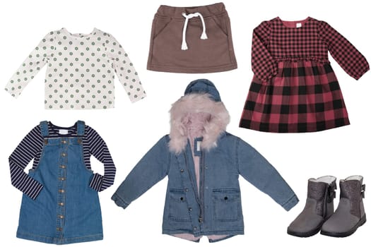 Collage set of little girl spring clothes isolated on a white background. The collection of a jeans jacket, shoes or boots, a jeans dress, a vest, a shirt and a skirt. Kids winter and autumn fashion.
