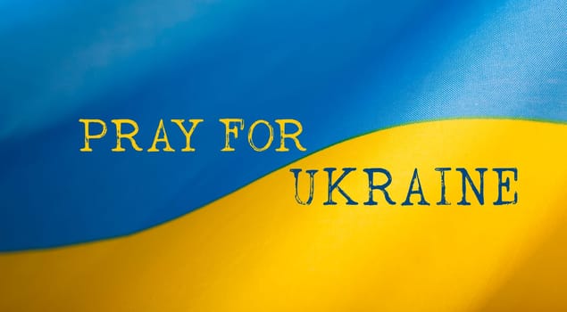 Pray for Ukraine concept background. National Ukrainian flag. Concept symbol of help support and no war in the country of Ukraine.