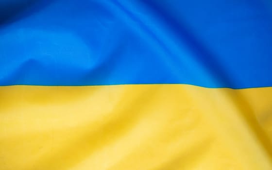 Flag of Ukraine, UA. Blue and yellow colors. Close up shot, background