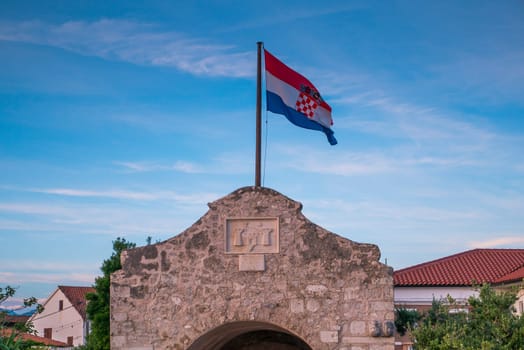 Croatian flag and gate tower to historic town Nin, Dalmatia, Croatia