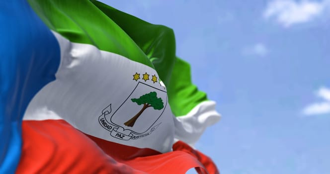 Detail of the national flag of Equatorial Guinea waving in the wind on a clear day. Equatorial Guinea is a country on the west coast of Central Africa. Selective focus.