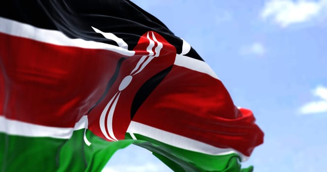 Detail of the national flag of Kenya waving in the wind on a clear day. Kenya is a country in Eastern Africa. Selective focus.