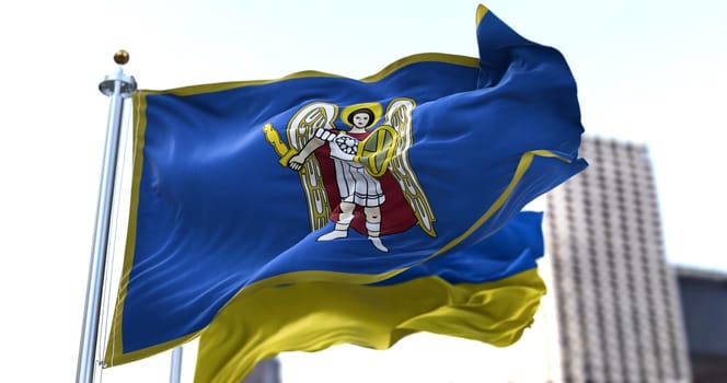 the city flag of Kiev with the depiction of the Archangel Gabriel waving with the Ukrainian national flag. The patron Saint of Kyiv Archangel Michael holding a flaming sword