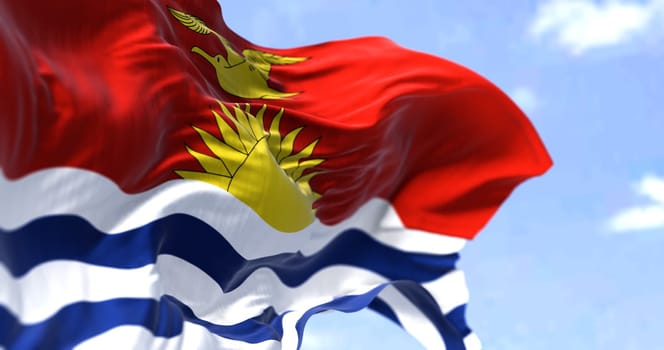 Detail of the national flag of Kiribati waving in the wind on a clear day. Kiribati is an independent island nation in the central Pacific Ocean. Selective focus.