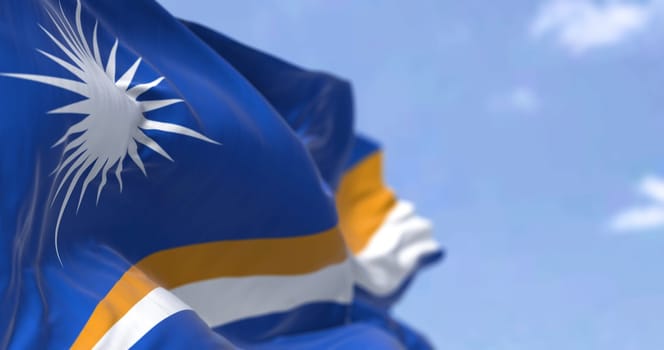 Detail of the national flag of Marshall Islands waving in the wind on a clear day. Marshall Islands is an independent island country near the Equator in the Pacific Ocean. Selective focus.