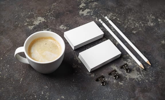 Corporate identity template on concrete background. Photo of blank stationery set and coffee cup.