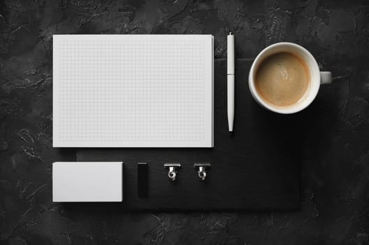 Blank stationery set on black plaster background. Corporate identity mockup. Responsive design template. Flat lay.