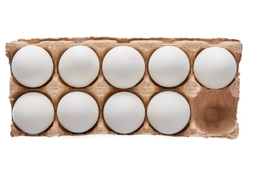 Nine white eggs on a cardboard stand on a white isolated background. High quality photo