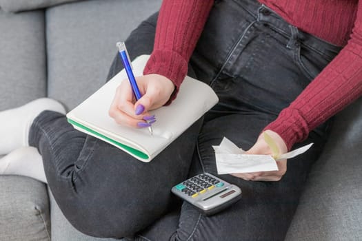 Home bills concept. Top view of woman calculating bills. Horizontally.