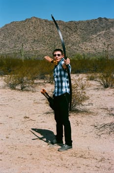 Young archer shooting a traditional long bow