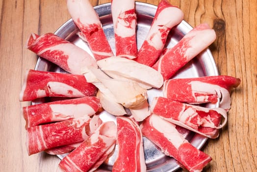 Raw pork on plate, Korean traditional style fresh pork beef belly BBQ, Japanese meat hot pot or Shabu in the restaurant, barbecue food