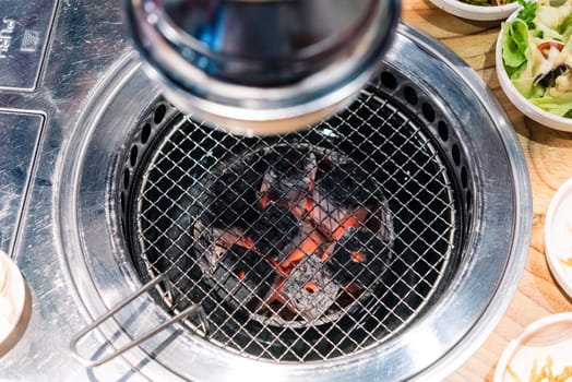 Korean BBQ stove and smoke hood. grill to place the meat to grill and below lit with charcoal at restaurant