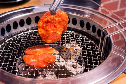 Korean beef barbecue on hot coals. Grill meat pork Korean BBQ traditional style on stove serve in restaurant, Japanese food