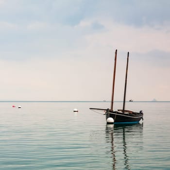 Boat reflecting over calm sea in Cancale, Brittany, France