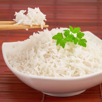 Japan rice with chopsticks on a bamboo mat