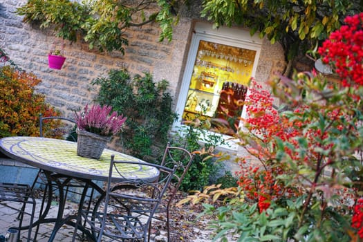 Country Cottage in France, cozy set of table and chairs in the garden, Bretagne, France.