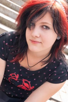 Punk emo girl, young adult with black red hair, looking at camera, close-up, horizontal