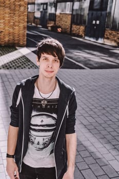 Young adult rock musician, looking at camera, singer wearing a blue sweatshirt, t-shirt, standing, brown hair and beard